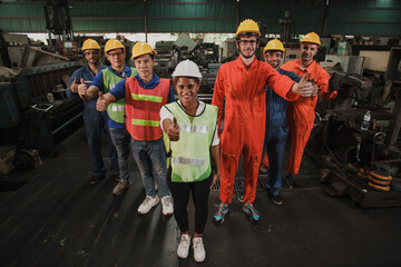 Workers showing thumbs up. group worker in factory on the machine