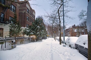Winter scene with snow covered cars parked along streets in Brooklyn, NY. Brownstones in winter...