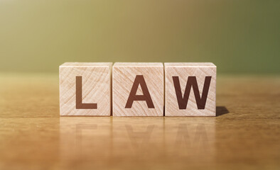LAW word written on wooden blocks on wooden table. Concept for your design.