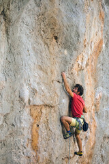 A climber is training on a natural terrain.