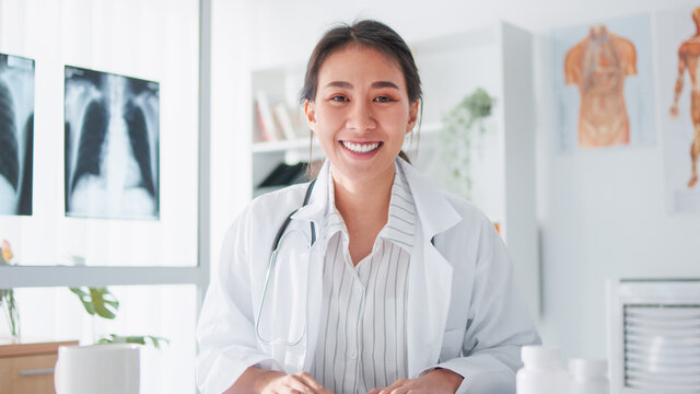 Portrait Of Asian Female Doctor Smiling, Look At Camera, Online Video Call Remote Meeting. Healthcare Job,Tele Medical, Telehealth, Hospital Clinic Health Care Service, Or Internet Technology Concept