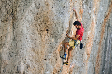 Fototapeta premium A climber is training on a natural terrain.