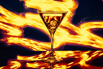 Glass of alcohol with ice on a fiery background - 410493561