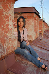 Asian woman in jeans sitting