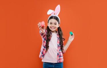 happy child girl in easter bunny ears having fun hold paited eggs, easter egg