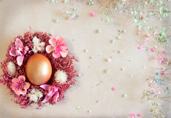 Easter egg lies on the table in dry flowers