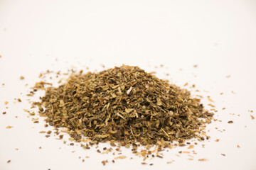 Crushed and dried basil leaves.