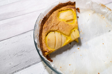 slice of pear tart in its baking pan