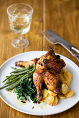 Roasted poussin with potatoes, mashed swede, green beans and creamy spinach