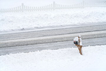 residential street after snow storm with snow plowed on sides