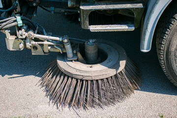 Close-up sweeper machine cleaning. Concept clean streets from debris. Selective focus.