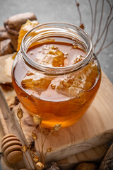 Honey comb and a jar of honey. A useful fortified bee product for health and beauty. Vegetarian dietary organic product. Beautiful still life.