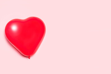 Heart shaped balloon on a pink background. Valentine's day concept.