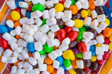 Mix of colorful Candies, delights and marshmallow on the plate. The sugar feast, any celebrations or children's party.