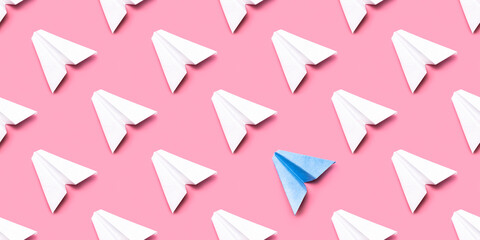 Pattern of paper planes. Seamless pattern with paper planes on a pink background.