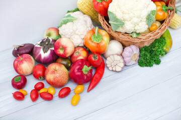 Composition with variety of fresh organic vegetables on white.