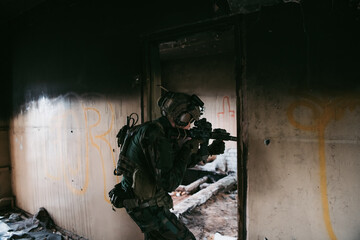 Soldier in combat. Urban combat training, soldier entering abandoned building. Anti terrorist operation battlefield training.