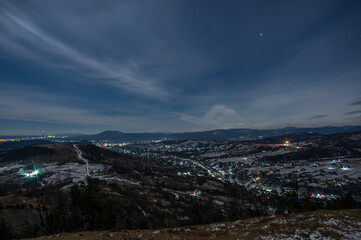 Panorama of a winter village at night in the mountains