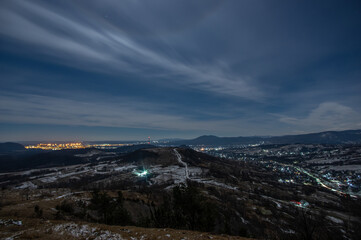Panorama of a winter village at night in the mountains