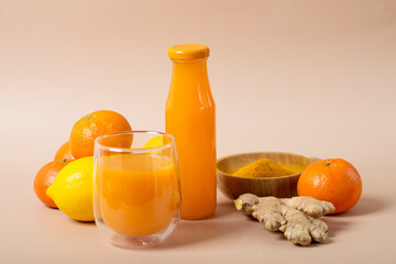 Ginger shot with citrus fruits juice, turmeric and honey.