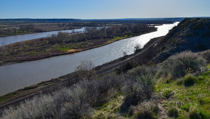 Valley with a slowly flowing river, glare of the sun. Montana nature