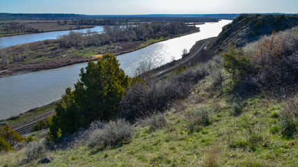 Valley with a slowly flowing river, glare of the sun. Montana nature