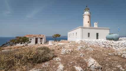 Moudari lighthouse with white painted building and shed under a blue sky at the island of Kythira in Greece