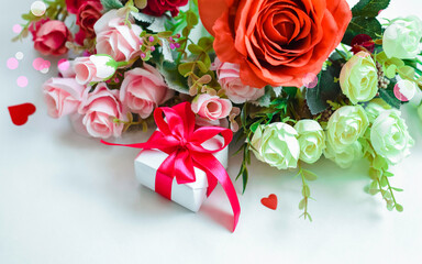 A postcard for Valentine's Day. Roses and a gift in red ribbon on a white background