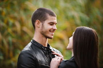 Fototapeta premium The guy with the girl lovers walk in the park autumn