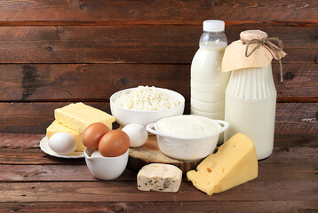 Assorted fresh dairy products, healthy breakfast with ingredients, natural nutrition concept, maintaining healthy intestinal microflora, diet nutrition, rustic table, selective approach