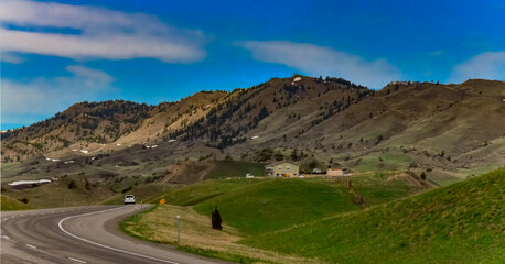 Mountain landscape, asphalt road in a valley among the mountains in Montana, USA
