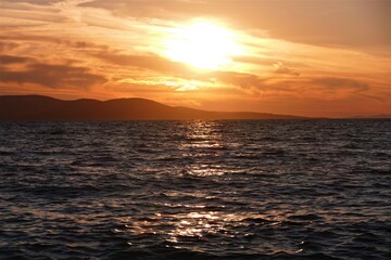 Fototapeta na wymiar Orange sunset in the sea and reflection