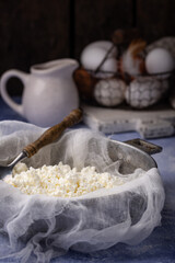 Homemade cottage cheese on blue background