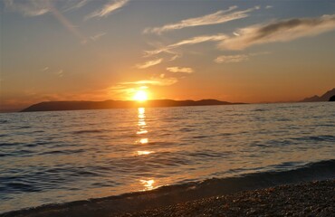 Orange sunset in the sea and reflection
