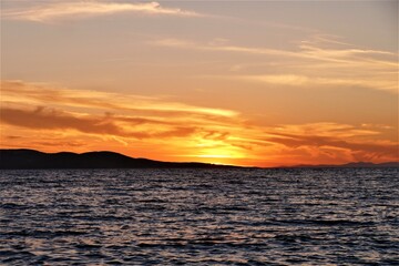 Orange sunset in the sea and reflection