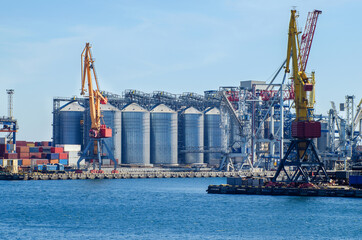 Lifting harbor cranes, shipping containers and granaries in the cargo seaport