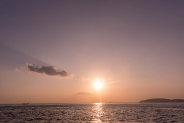 Vintage and retro toning of tropical beach with blue sky and clear sea which including of a wooden umbrella and chair in sunrise time with vintage retro tone. Vacation time as concept.	