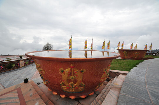 Containers with holy water in front of the Buddha statue in Tathagata Tsal (Buddha park)