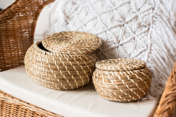 two wicker baskets made of vine, on a rattan chair. pillow macrame. eco, natural materials, eco-friendly. boho style
