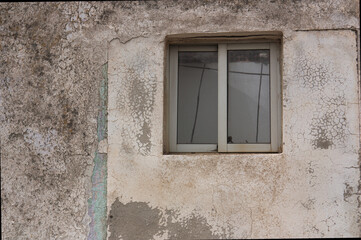 Fototapeta na wymiar Wall worn by time with window and copy space