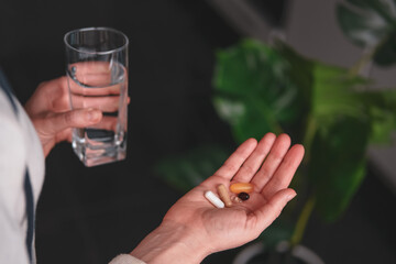 Woman taking various pills. Nutrition supplements concept.