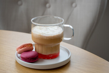 A cup of coffee with iice cream, syrup and macaroons on the table. High quality photo