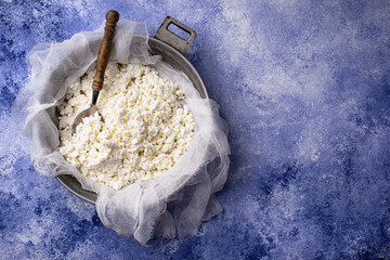 Homemade cottage cheese on blue background