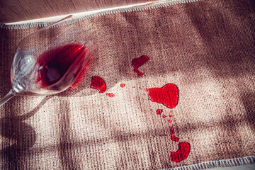 poured red wine on the table, drops of red wine