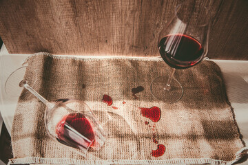 poured red wine on the table, drops of red wine