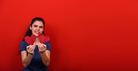 Adorable girl with valentines day heart showing love fun affection portrait on red background
