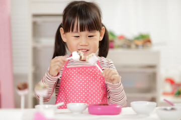 young  girl pretend play food preparing at home
