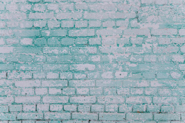 grunge background: faded brick wall with whitewash and remnants of green paint