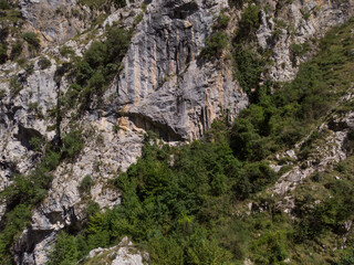 The Cares Route in the heart of Picos de Europa National Park, Cain-Poncebos, Asturias, Spain. Narrow and impressive canyon between cliffs, bridges, caves, footpaths and rocky mountains.