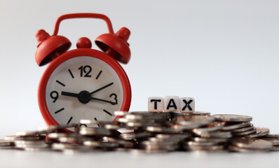 coins, clock and tax on background.
